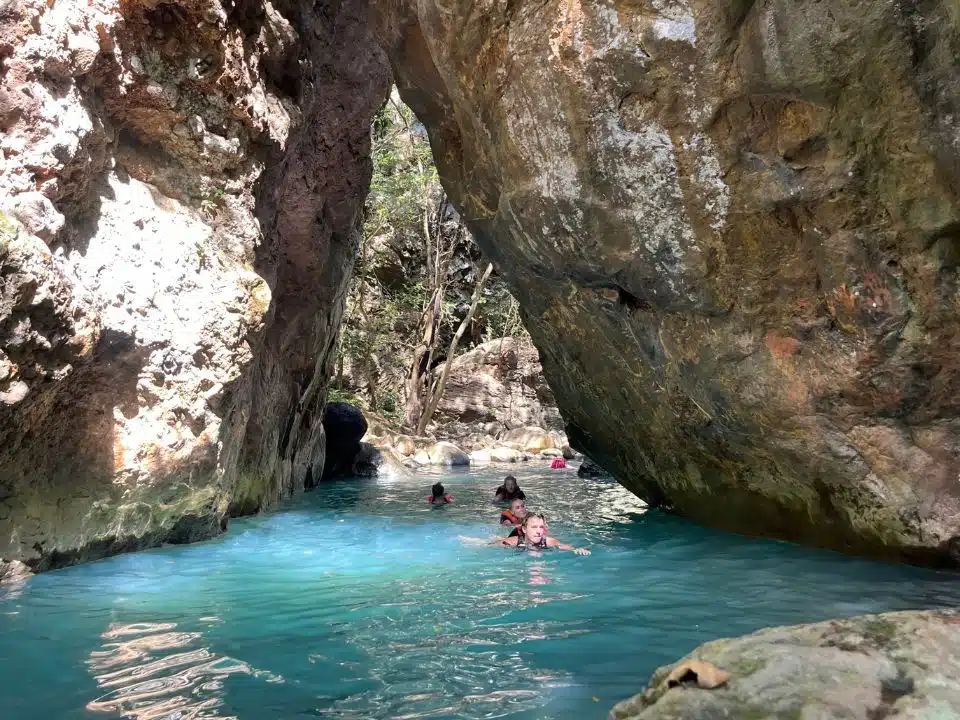 A group of people swimming during the waterfall tour